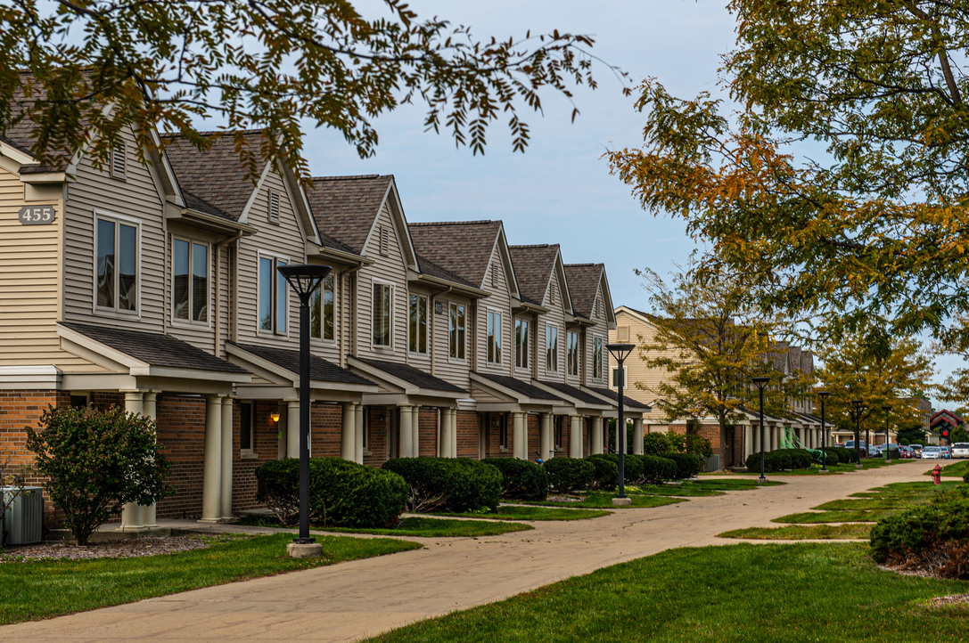 Row of apartments with shaded sidewalks